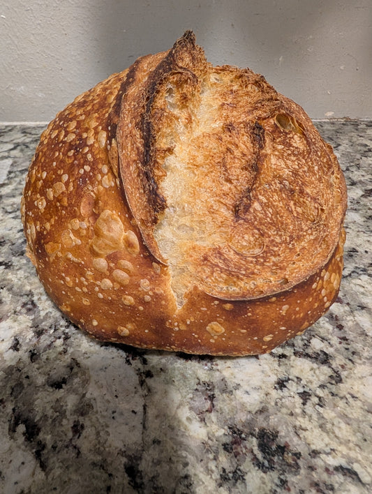 Crumbs. Rustic round sourdough plain bread.