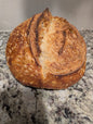 Crumbs. Rustic round sourdough plain bread.